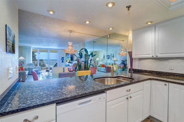 2504 Gulf Blvd Unit 201, Indian Rocks Beach, FL 33785 - kitchen featuring white dishwasher, a sink, a peninsula, white cabinetry, and a textured ceiling