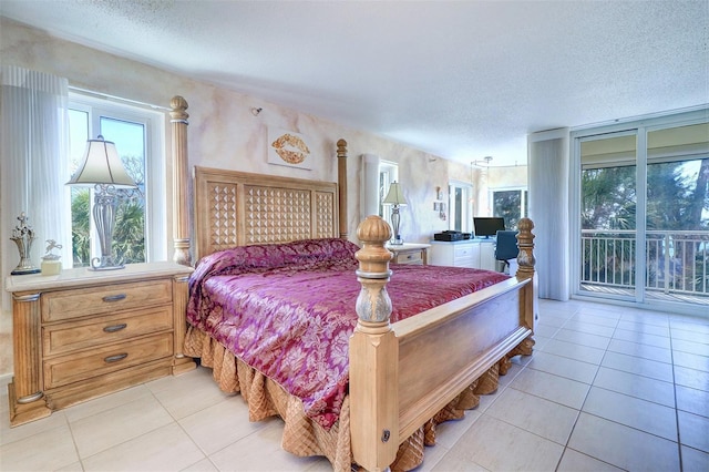 2504 Gulf Blvd Unit 201, Indian Rocks Beach, FL 33785 - bedroom with access to exterior, light tile patterned floors, and a textured ceiling