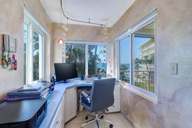 2504 Gulf Blvd Unit 201, Indian Rocks Beach, FL 33785 - home office with light tile patterned floors and a textured wall