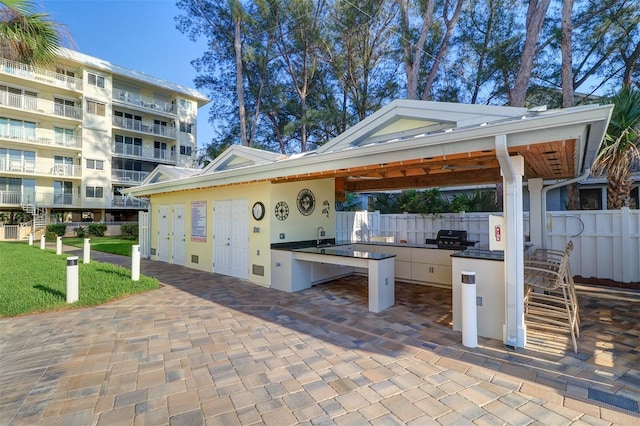 2504 Gulf Blvd Unit 201, Indian Rocks Beach, FL 33785 - view of patio with fence, an outdoor kitchen, and exterior bar