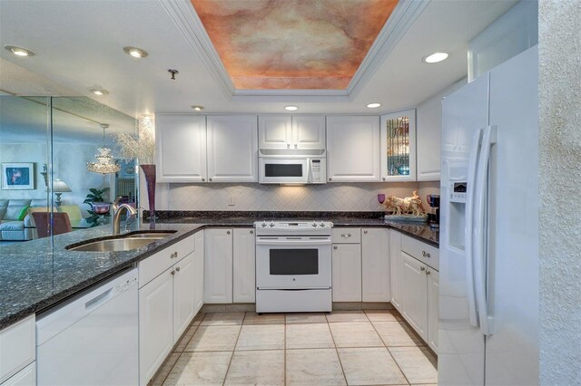 2504 Gulf Blvd Unit 201, Indian Rocks Beach, FL 33785 - kitchen featuring white appliances, a raised ceiling, backsplash, white cabinetry, and recessed lighting