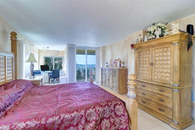 2504 Gulf Blvd Unit 201, Indian Rocks Beach, FL 33785 - bedroom with access to outside, a textured ceiling, tile patterned floors, and an office area