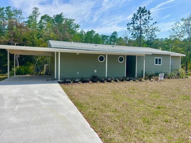 6952 W Barbara Ann Ln, Homosassa, FL 34446 - ranch-style home featuring a front yard, concrete driveway, and an attached carport