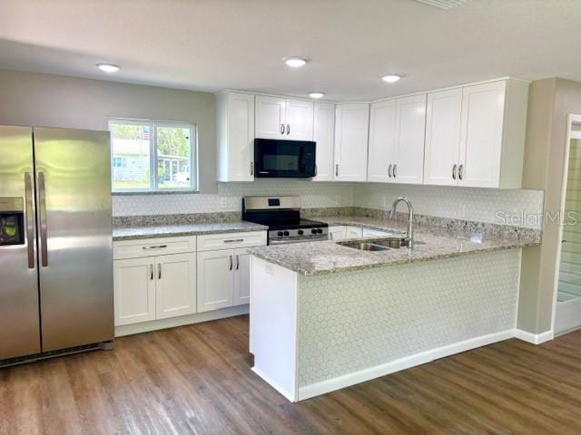 6952 W Barbara Ann Ln, Homosassa, FL 34446 - kitchen with stainless steel appliances, a sink, white cabinetry, and recessed lighting
