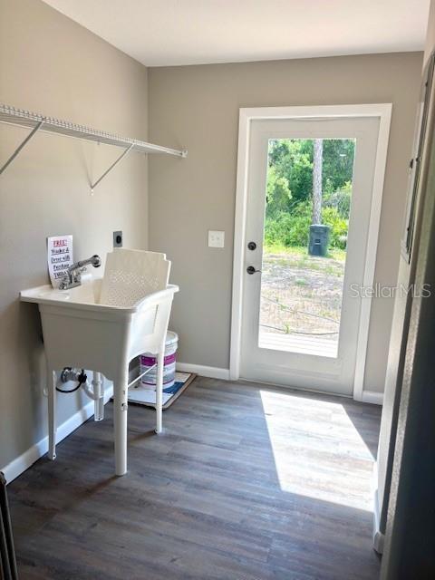 6952 W Barbara Ann Ln, Homosassa, FL 34446 - clothes washing area featuring hookup for an electric dryer, baseboards, and wood finished floors