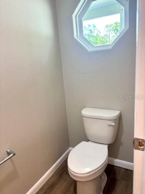 6952 W Barbara Ann Ln, Homosassa, FL 34446 - bathroom with wood finished floors, baseboards, and toilet