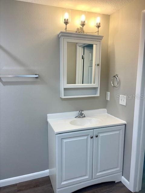 6952 W Barbara Ann Ln, Homosassa, FL 34446 - bathroom with baseboards, vanity, and wood finished floors