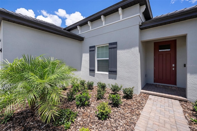 10098 Banyan Breeze Blvd, Land O Lakes, FL 34638 - doorway to property featuring stucco siding