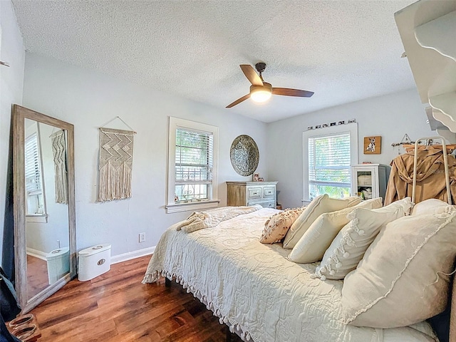 1221 E Hamilton Ave, Tampa, FL 33604 - bedroom featuring wood finished floors, a textured ceiling, baseboards, and a ceiling fan