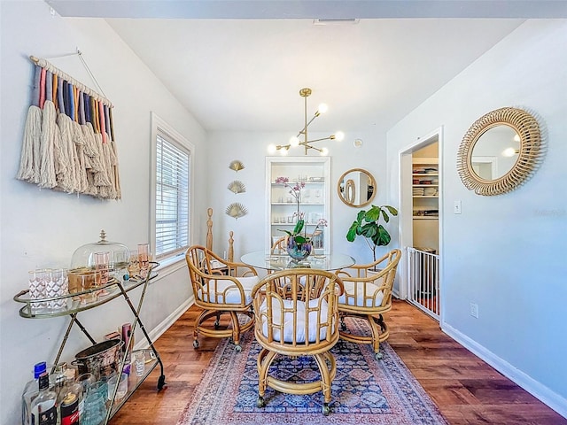 1221 E Hamilton Ave, Tampa, FL 33604 - dining space with a chandelier, wood finished floors, and baseboards