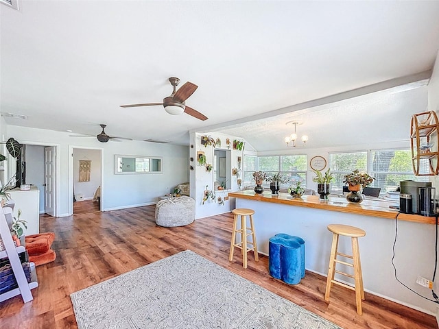 1221 E Hamilton Ave, Tampa, FL 33604 - living area featuring wood finished floors, a chandelier, and ceiling fan