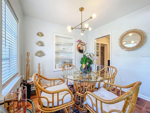 1221 E Hamilton Ave, Tampa, FL 33604 - dining room with plenty of natural light, wood finished floors, a chandelier, and baseboards