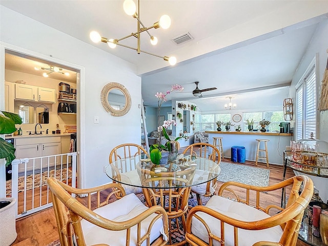 1221 E Hamilton Ave, Tampa, FL 33604 - dining room featuring a chandelier, light wood-type flooring, and a ceiling fan