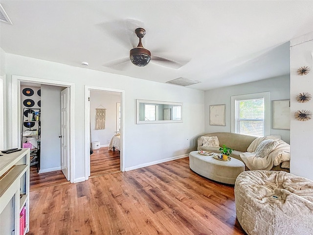 1221 E Hamilton Ave, Tampa, FL 33604 - living room with light wood-style floors, baseboards, and ceiling fan