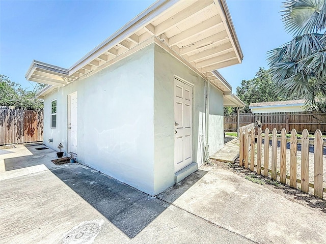 1221 E Hamilton Ave, Tampa, FL 33604 - view of side of home featuring a fenced backyard, a patio area, and stucco siding