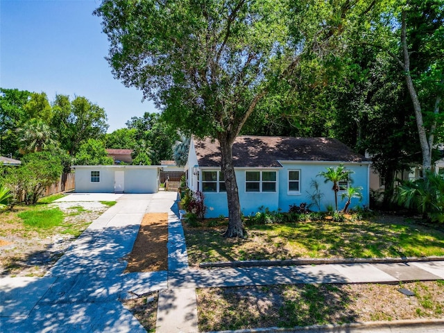 1221 E Hamilton Ave, Tampa, FL 33604 - view of front of house with stucco siding, driveway, and a shingled roof