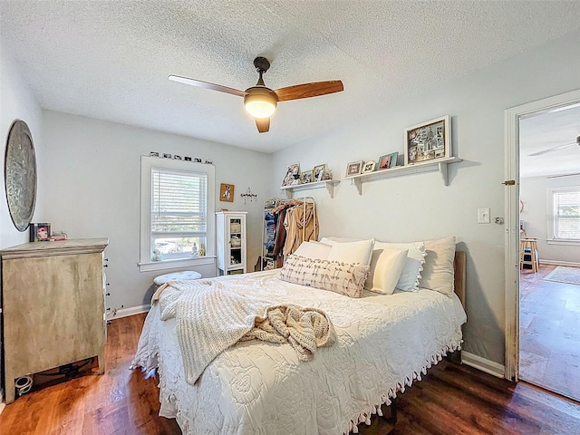 1221 E Hamilton Ave, Tampa, FL 33604 - bedroom with wood finished floors, baseboards, a ceiling fan, and a textured ceiling