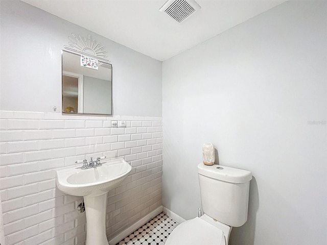 1221 E Hamilton Ave, Tampa, FL 33604 - bathroom featuring toilet and tile walls