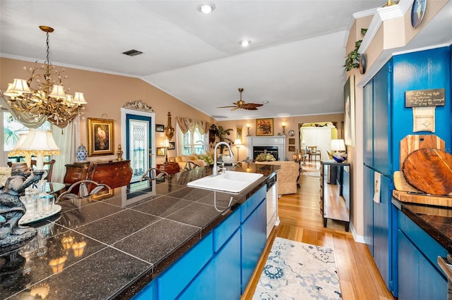 420 Hanby St, Crystal Beach, FL 34681 - kitchen featuring a sink, blue cabinets, open floor plan, tile counters, and lofted ceiling