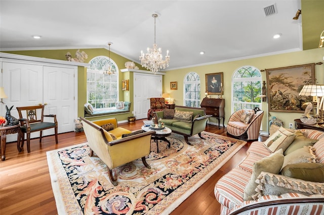 420 Hanby St, Crystal Beach, FL 34681 - living room featuring a chandelier, plenty of natural light, wood finished floors, vaulted ceiling, and crown molding