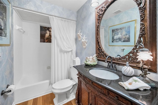 420 Hanby St, Crystal Beach, FL 34681 - bathroom featuring wood finished floors, toilet, vanity, and shower / bathtub combination with curtain
