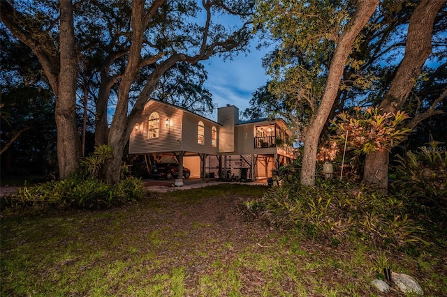 420 Hanby St, Crystal Beach, FL 34681 - back of house with a balcony and a chimney