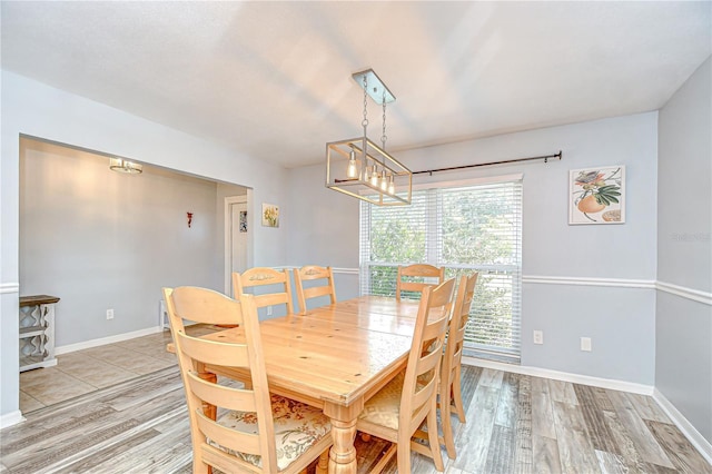 2524 Laurelwood Ln, Valrico, FL 33596 - dining space with light wood-style floors, baseboards, and a chandelier
