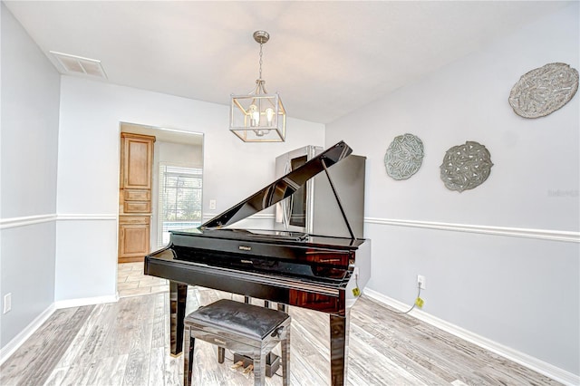 2524 Laurelwood Ln, Valrico, FL 33596 - sitting room featuring light wood-type flooring, baseboards, and a chandelier