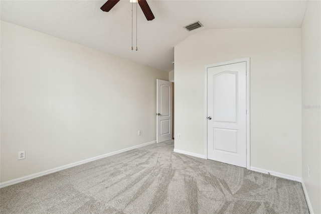 unfurnished bedroom featuring lofted ceiling, carpet floors, baseboards, and ceiling fan