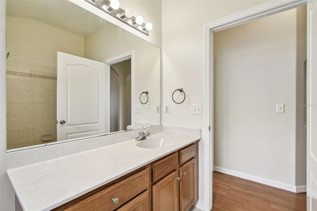 bathroom featuring wood finished floors, vanity, and baseboards
