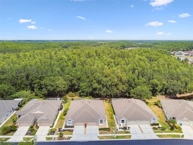 aerial view of residential area with a heavily wooded area