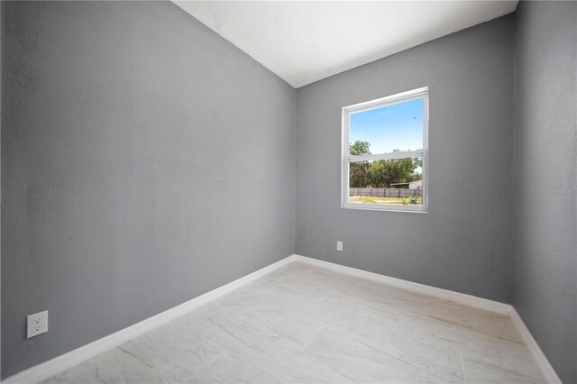 11009 Spivey Rd Unit 1, Gibsonton, FL 33534 - unfurnished room featuring vaulted ceiling and baseboards