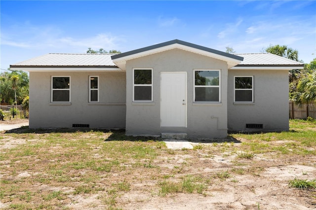 11009 Spivey Rd Unit 1, Gibsonton, FL 33534 - back of house with crawl space, metal roof, and fence