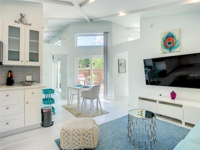 5111 28th Ave N, Saint Petersburg, FL 33710 - living room featuring beam ceiling, a towering ceiling, recessed lighting, and baseboards