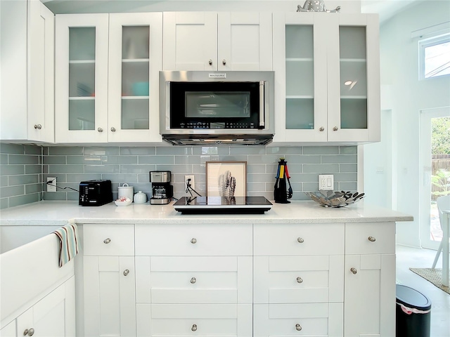 5111 28th Ave N, Saint Petersburg, FL 33710 - bar featuring stainless steel microwave, backsplash, and black electric stovetop
