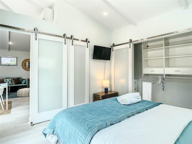 5111 28th Ave N, Saint Petersburg, FL 33710 - bedroom with a barn door, wood finished floors, and a closet