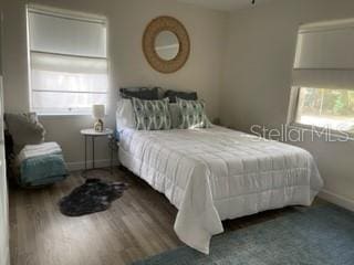 5111 28th Ave N, Saint Petersburg, FL 33710 - bedroom featuring multiple windows, baseboards, and wood finished floors