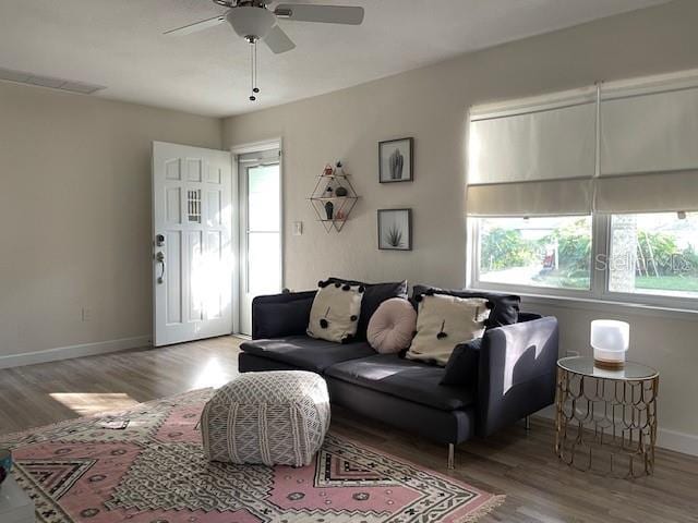 5111 28th Ave N, Saint Petersburg, FL 33710 - living room featuring a ceiling fan, wood finished floors, and baseboards