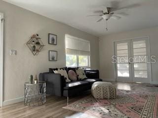 5111 28th Ave N, Saint Petersburg, FL 33710 - living area featuring ceiling fan, wood finished floors, baseboards, and french doors