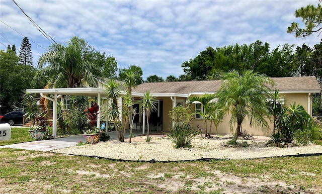 7425 W Maryland Ave W, Hudson, FL 34667 - view of front of property with a carport and stucco siding