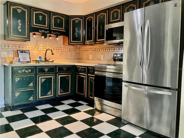 7425 W Maryland Ave W, Hudson, FL 34667 - kitchen featuring appliances with stainless steel finishes, tile patterned floors, light countertops, a sink, and tasteful backsplash