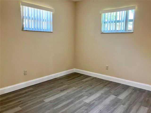 7425 W Maryland Ave W, Hudson, FL 34667 - spare room with dark wood-type flooring and baseboards