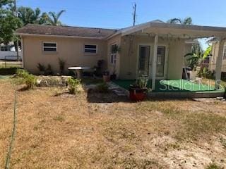 7425 W Maryland Ave W, Hudson, FL 34667 - back of house featuring stucco siding