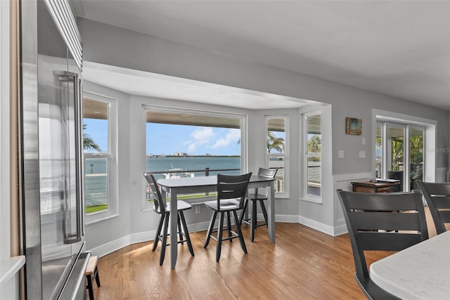 297 1st St W, Tierra Verde, FL 33715 - dining space with wood finished floors and a water view