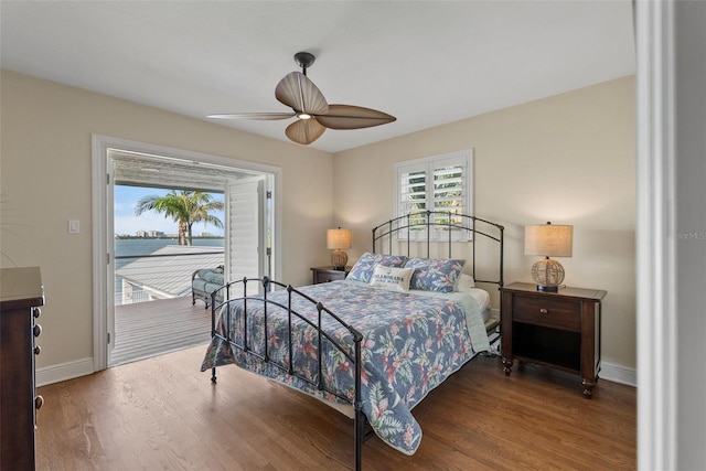 297 1st St W, Tierra Verde, FL 33715 - bedroom featuring access to exterior, wood finished floors, a ceiling fan, and a water view