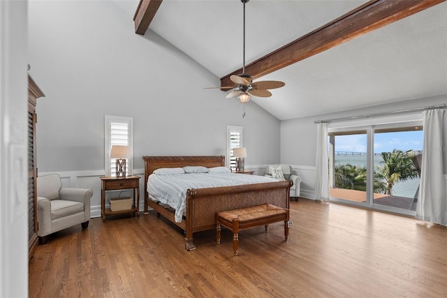 297 1st St W, Tierra Verde, FL 33715 - bedroom with access to exterior, beam ceiling, wainscoting, wood finished floors, and high vaulted ceiling