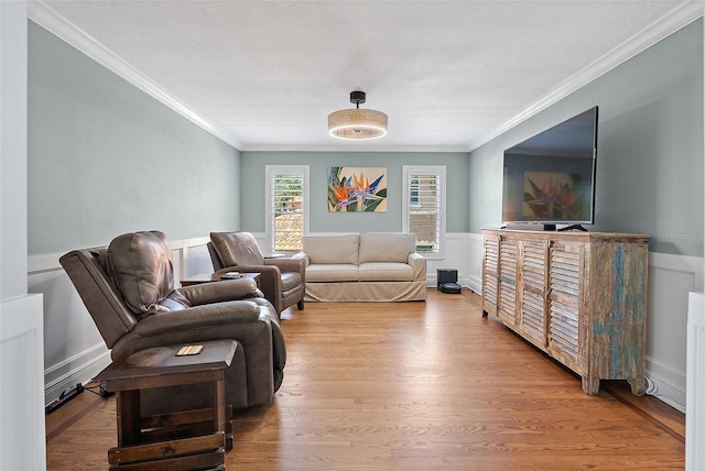 297 1st St W, Tierra Verde, FL 33715 - living area with ornamental molding, wood finished floors, and a wainscoted wall