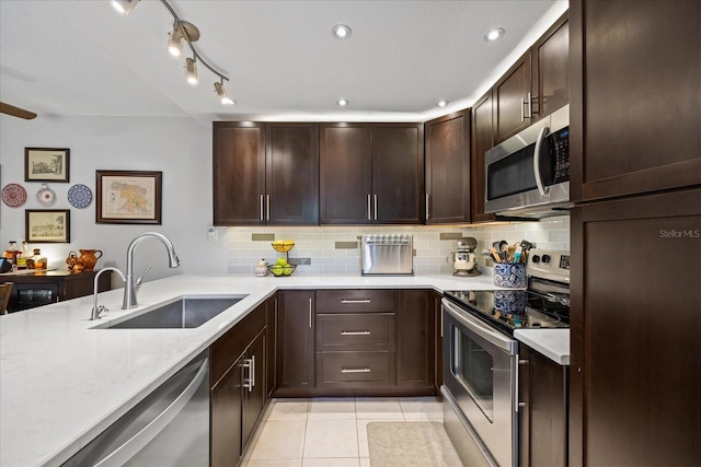 2626 2nd Ct, Palm Harbor, FL 34684 - kitchen featuring appliances with stainless steel finishes, a sink, decorative backsplash, light tile patterned floors, and recessed lighting