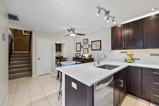 2626 2nd Ct, Palm Harbor, FL 34684 - kitchen featuring a sink, dishwasher, ceiling fan, backsplash, and a peninsula