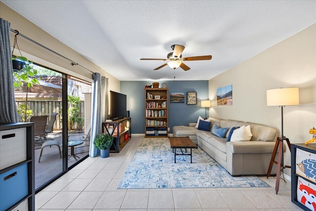 2626 2nd Ct, Palm Harbor, FL 34684 - living area featuring ceiling fan, light tile patterned floors, a textured ceiling, and baseboards